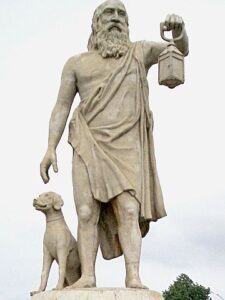 Statue of Diogenes holding a lantern and standing next to a seated dog