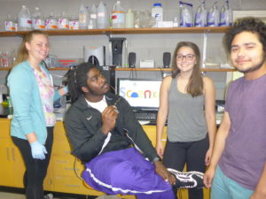 Anne, AJ, Julia, and Bryan contemplating science in the lab.