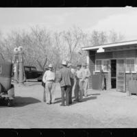 [Untitled photo, possibly related to: Migratory worker at coop store gass station, FSA (Farm Security Administration) camp, Weslaco, Texas]